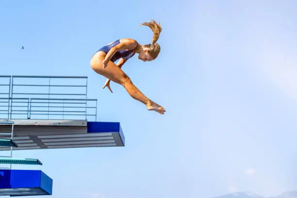 Photo of Female springboard diver jump