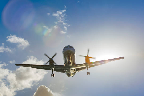 istock Propeller airplane landing at sunset front view 1090161786
