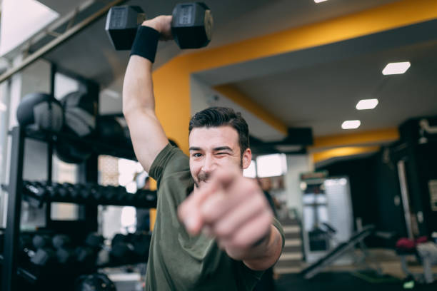 istock Muscular man is doing squats with dumbbell 1090164212