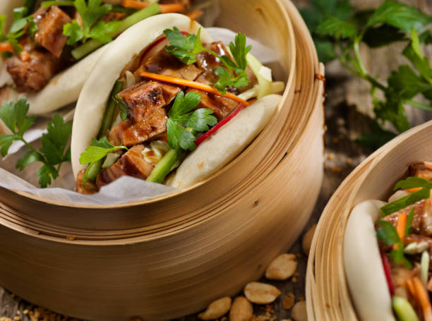 Pork Belly Bao Buns Pork Belly Bao Buns with Carrots, Coleslaw and Cilantro with a Savory Sauce chinese food photos stock pictures, royalty-free photos & images