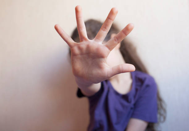 istock Little girl protects herself with an open palm 1090167116