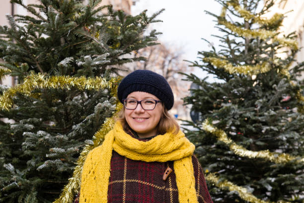 istock Happy Woman standing by the Christmas Tree 1090169512