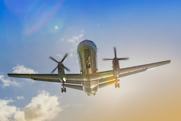 istock Propeller airplane landing at sunset front view 1090169614