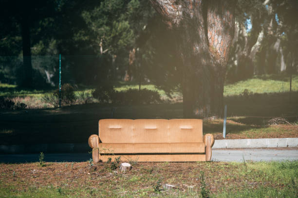 istock Old sofa couch abandoned in the middle of a field 1090169680