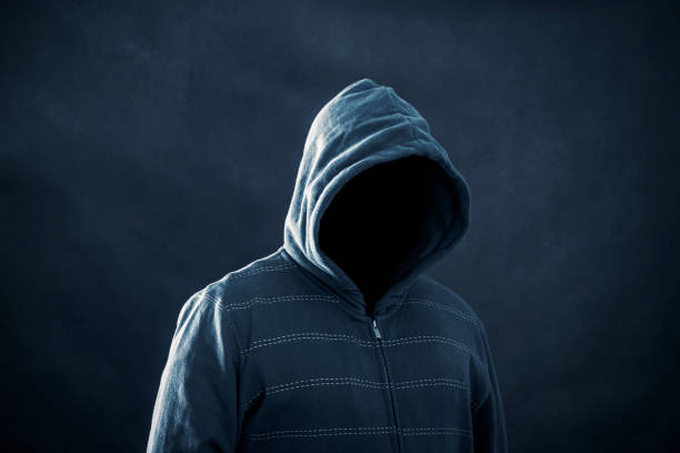 istock Hooded man with black mask in the dark 1090180852