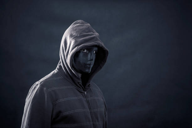 istock Hooded man with black mask in the dark 1090181130