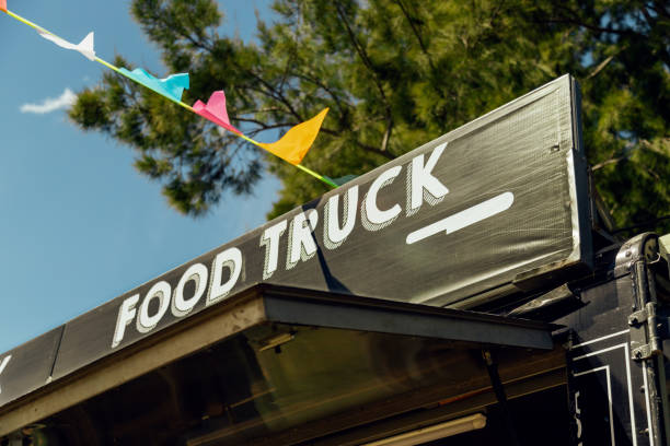 Signboard of a food truck with colorful pennants stock photo