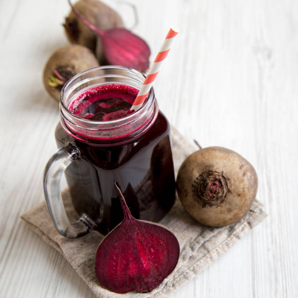 istock Glass jar mug filled with beetroot smoothie, side view. Close-up. 1090192662