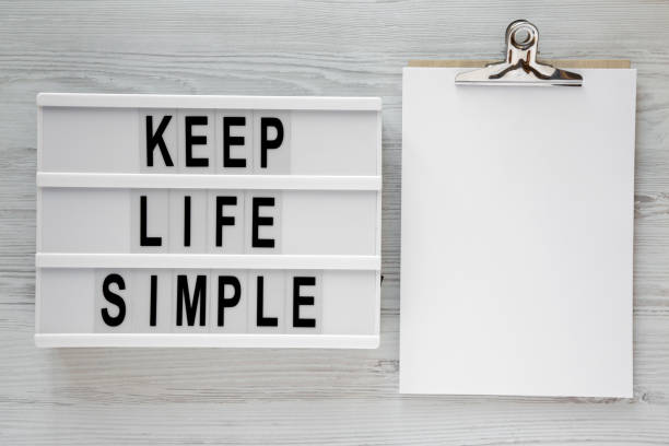 istock 'Keep life simple' words on modern board, clipboard over white wooden surface, top view. Flat lay, from above, overhead. Space for text. 1090192920