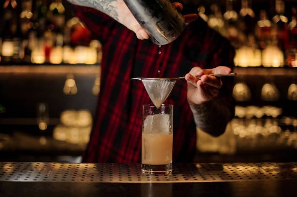 istock Bartender pouring a Lemonade cocktail from the steel shaker 1090196162