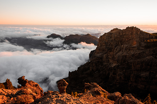 GRAN CANARIA, SPAIN - NOVEMBER 6, 2018: Roque Nublo mountain under the clear sky among white clouds during sunrise