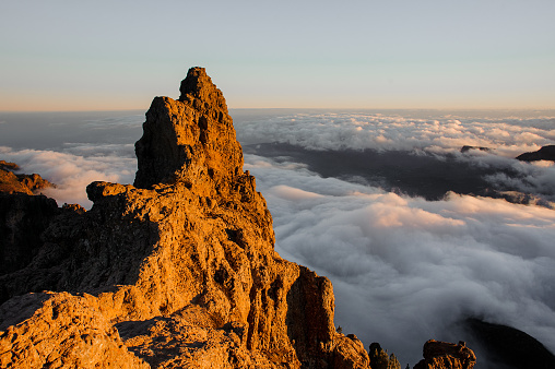 GRAN CANARIA, SPAIN - NOVEMBER 6, 2018: Morning landscape of Roque Nublo mountain under the sunlight among clouds under the sky