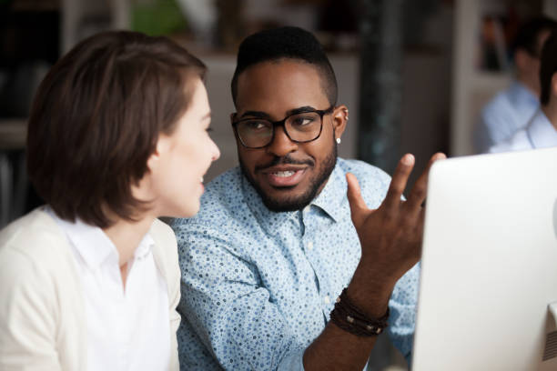 istock Creative african american and caucasian workers discussing work chatting 1090214848