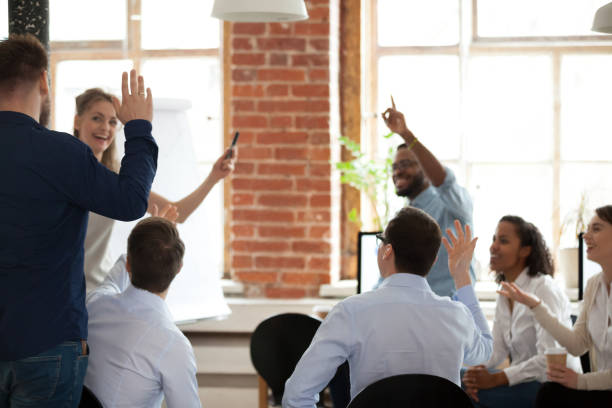 istock Business people raising hands voting asking questions at corporate training 1090215700