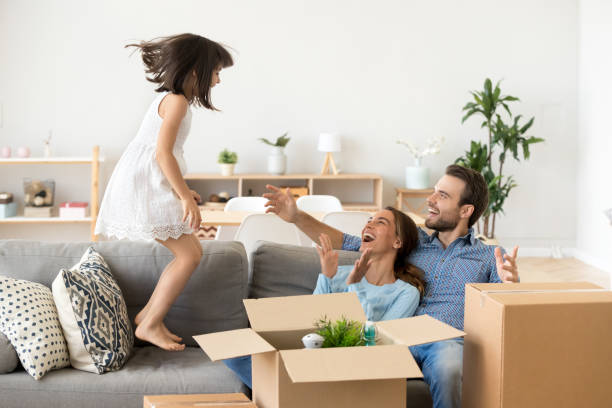 istock Kid girl having fun jumping on sofa on moving day 1090217384