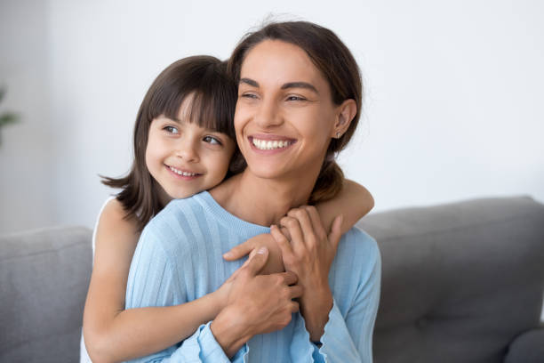 istock Smiling mom and cute kid daughter embracing looking into future 1090217400