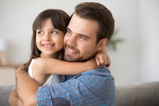 istock Hopeful single dad embracing kid daughter looking into bright future 1090217458