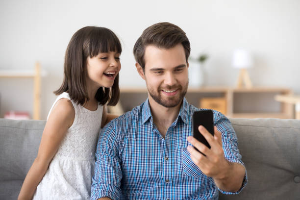 istock Happy dad taking selfie with kid on smartphone at home 1090217586