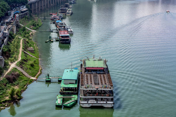 Shibaozhai, Chongqing, China - May 23, 2014. Two men traveling down the Yangtze river by Sampan. The river is an integral part of China, it is used for water, irrigation, transportation, industry and boundary-marking.