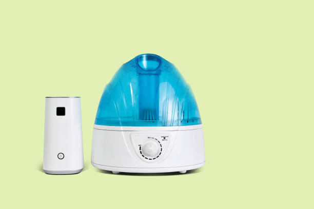 istock A white-blue air humidifier isolated on a yellow pastel background. 1090222532