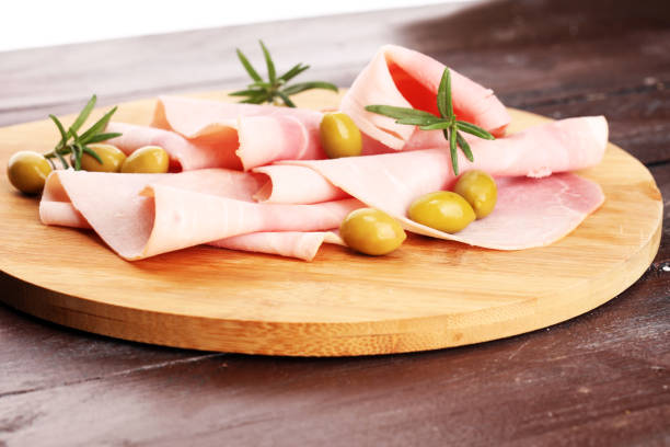 istock Sliced ham on wooden background. Fresh prosciutto. Pork ham sliced. 1090223714