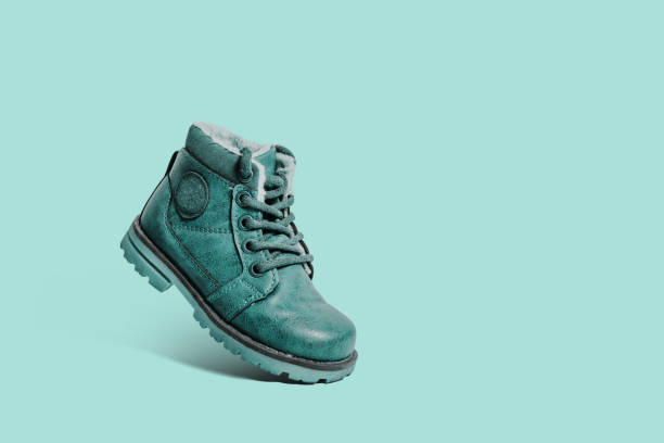 istock Leather, green children's shoe on a pastel green background. 1090223974