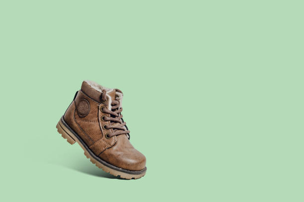 istock Leather, children's shoe on a pastel green background. 1090223980
