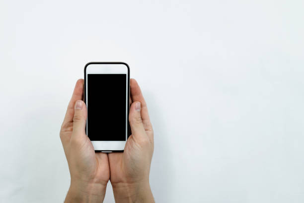 istock Two hands are holding a white cell phone with a blank black display. 1090224108