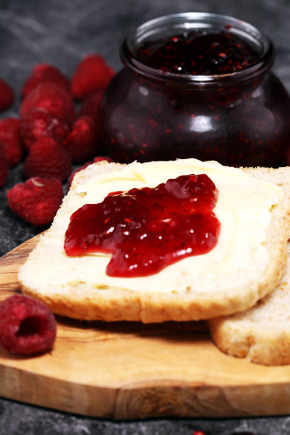 istock Toast bread with homemade raspberry jam or marmalade on rustic table served with butter for breakfast or brunch 1090231236