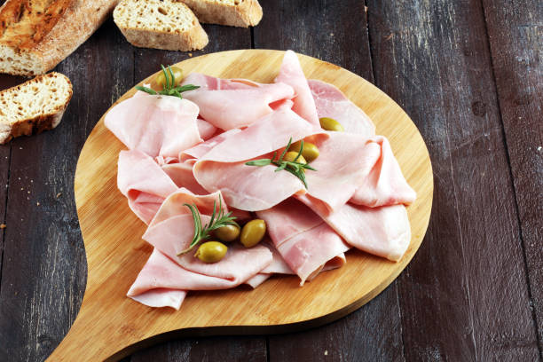 istock Sliced ham on wooden background. Fresh prosciutto. Pork ham sliced. 1090231426