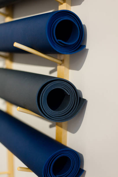 istock Yoga Mats Hanging on a Rack 1090231728