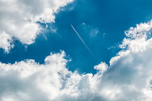 A plane above the clouds in the deep blue sky