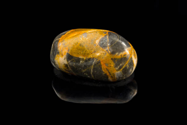istock Colorful stone with different designs and colors and black background 1090236584