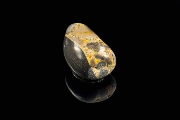 istock Colorful stone with different designs and colors and black background 1090236610