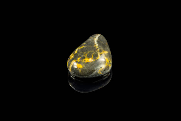 istock Colorful stone with different designs and colors and black background 1090236720
