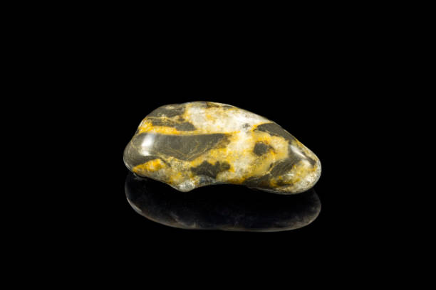 istock Colorful stone with different designs and colors and black background 1090236832