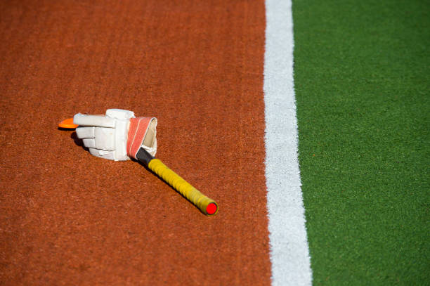 istock Glove with a yellow stick on brown and green grass 1090239592