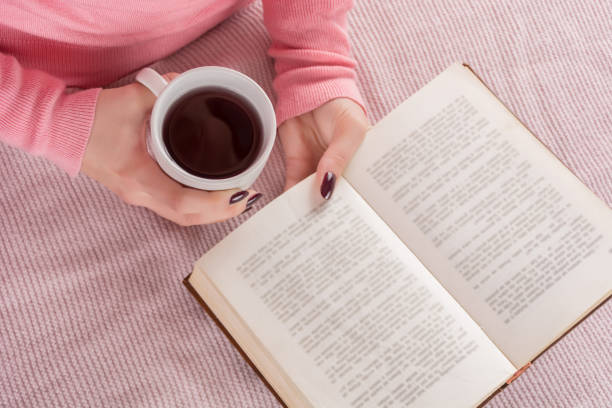 istock Girl with cup of tea and book 1090241664