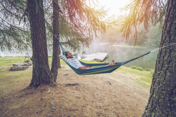 istock Cheerful man relaxing on hammock in mountain scenery, Switzerland 1090242130