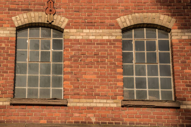 istock Old empty brick house factory with dark windows 1090242258