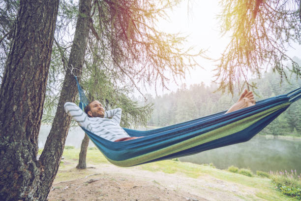 istock Cheerful man relaxing on hammock in mountain scenery, Switzerland 1090242352
