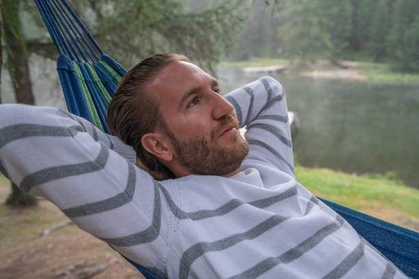istock Cheerful man relaxing on hammock in mountain scenery, Switzerland 1090242376
