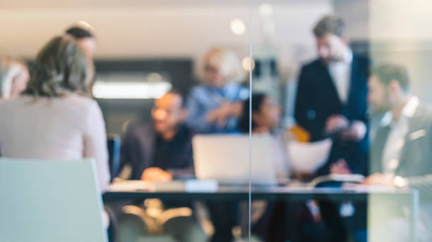 Business team background Out of focus image of a group of business people working in the office defocused stock pictures, royalty-free photos & images