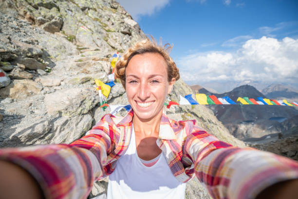 istock Hiker on mountain summit in the Swiss Alps, Himalayan flags 1090247222