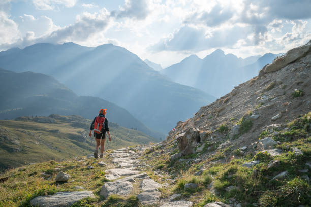 istock Young woman hiking and walking on mountain trail 1090253992