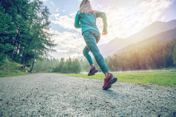 Sportive young woman jogging outdoors, trail running experience. People body conscious and heathy lifestyle concept. Sportive young woman jogging outdoors, trail running experience. People body conscious and heathy lifestyle concept. heathy stock pictures, royalty-free photos & images