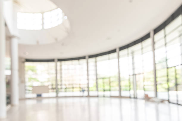 istock Blur background interior view looking out toward to empty office lobby and entrance doors and glass curtain wall 1090261948