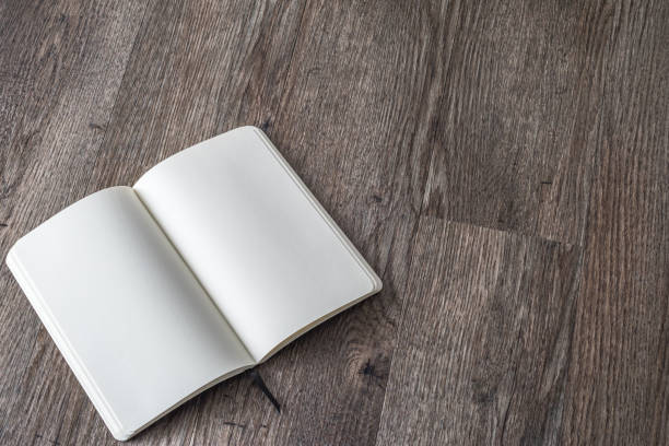istock Blank book mock up, catalog, magazines, brochure, or note cover template, white paper texture on wood table 1090261950