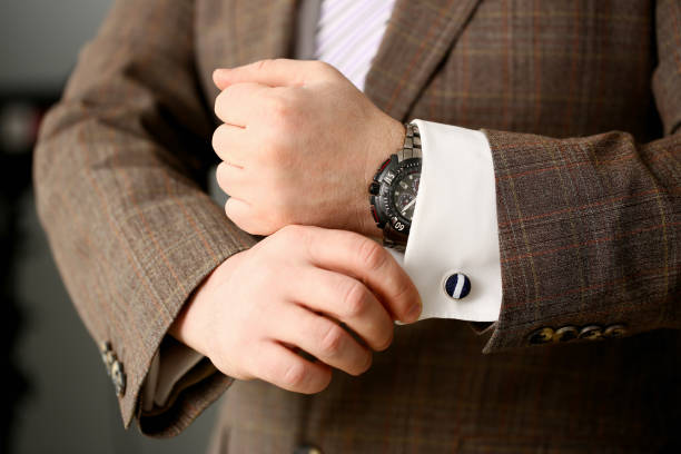 istock Male arm in brown suit set stud closeup 1090262450