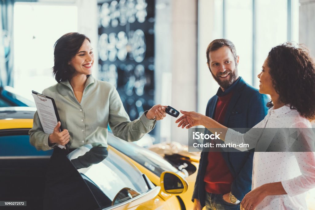 Woman enjoying a new car Young man surprising his wife with buying a new car Car Stock Photo